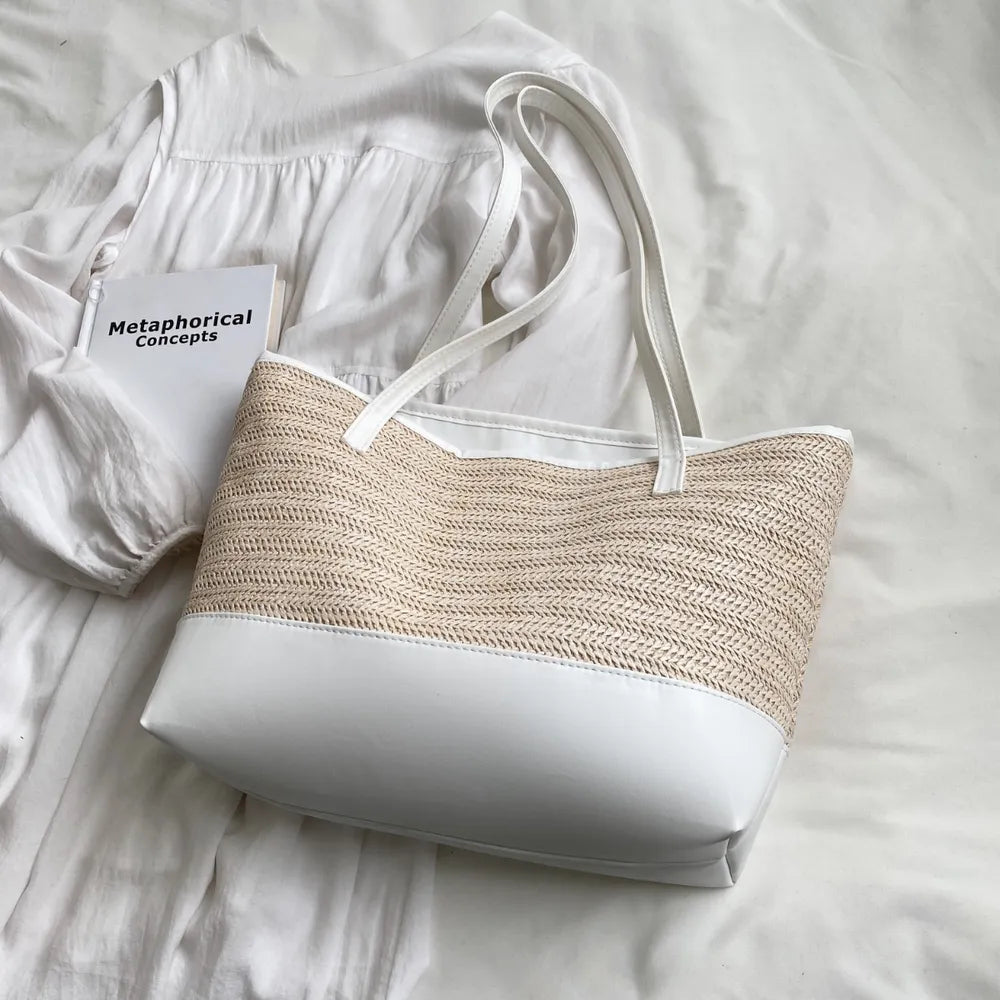 Large white straw bag laying down on white cloth.