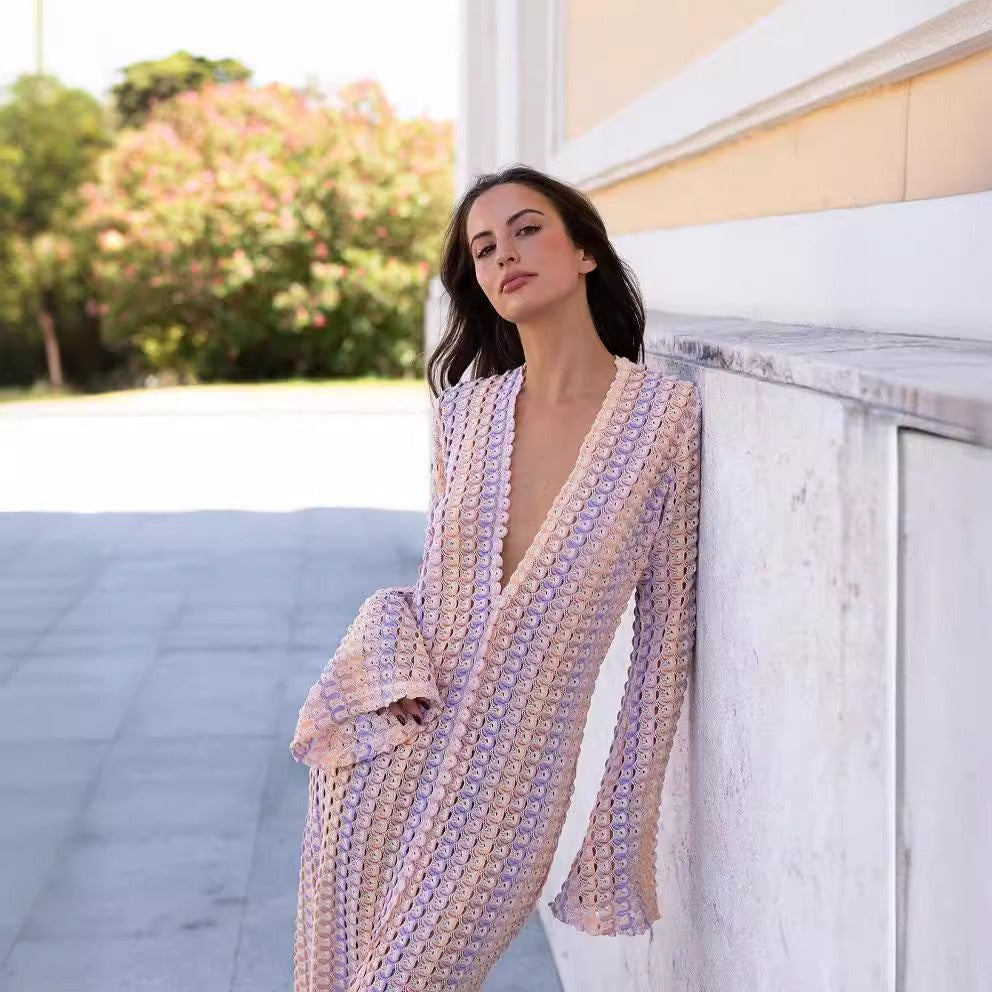 Person standing in a colorful swimwear dress cover-up with a patterned design.