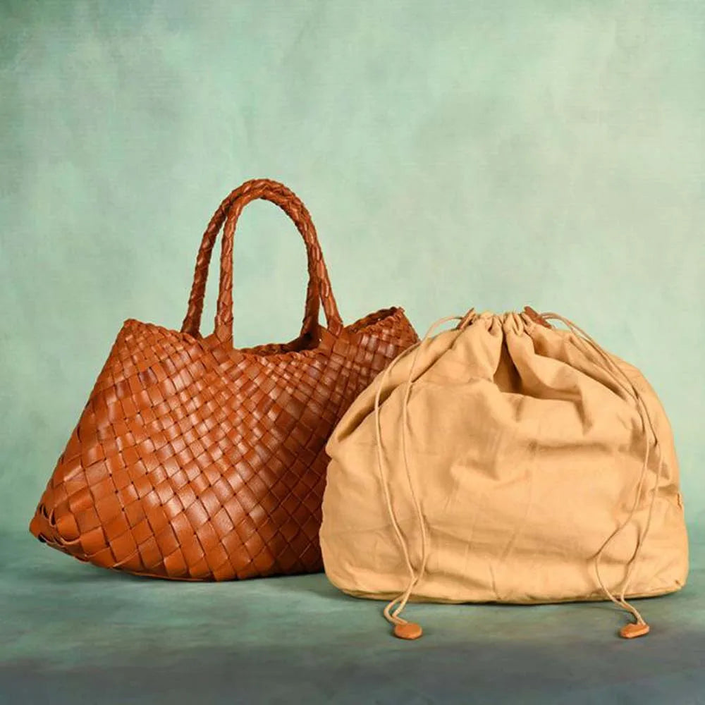 Brown woven handbag on against a plain background