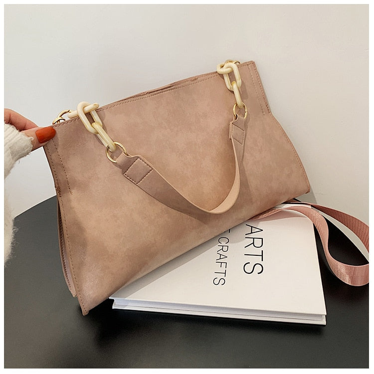Large women's shoulder bag in soft faux leather, front view showing smooth finish and slim silhouette, black variant. Sold at PeachyBeanz.