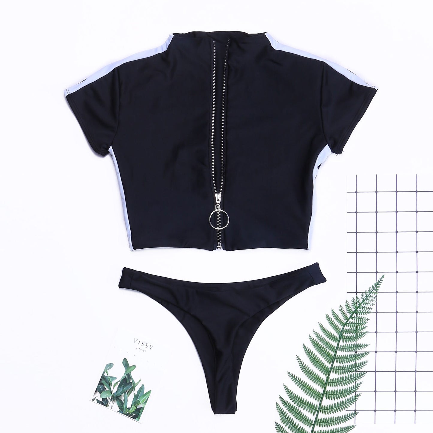 Women’s short‑sleeve two‑piece swimsuit with a front zip‑up top and matching bikini bottoms, shown in a solid color on a plain background.