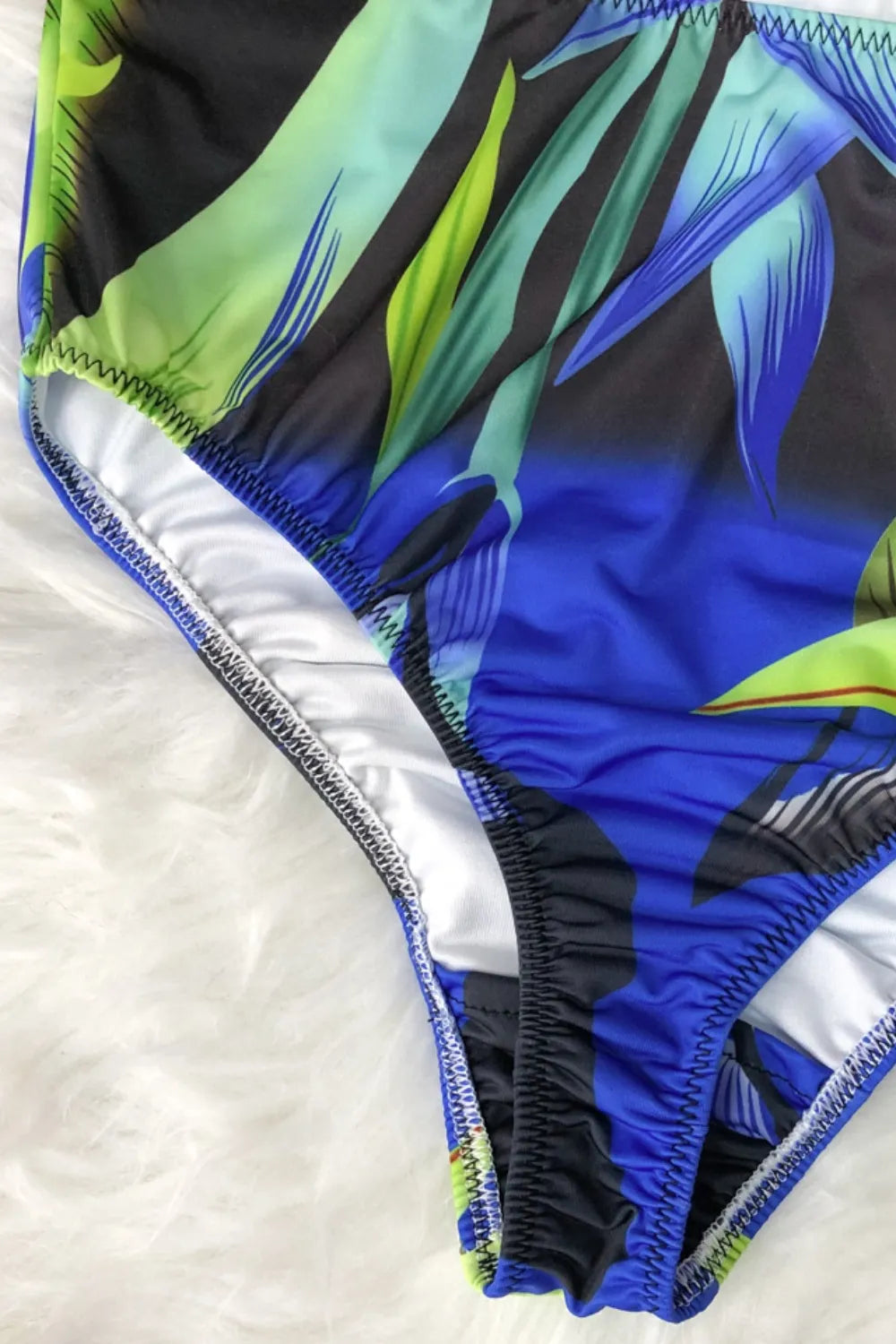 Close‑up of halter tie and printed fabric showing texture and vibrant colorway.