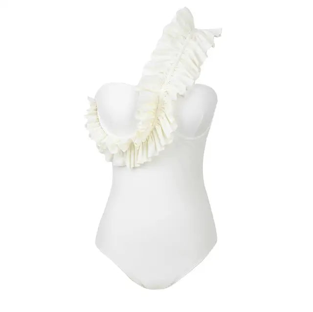 White ruffle backless one‑piece swimsuit with high‑cut leg and ruffle trim, shown against a neutral background.