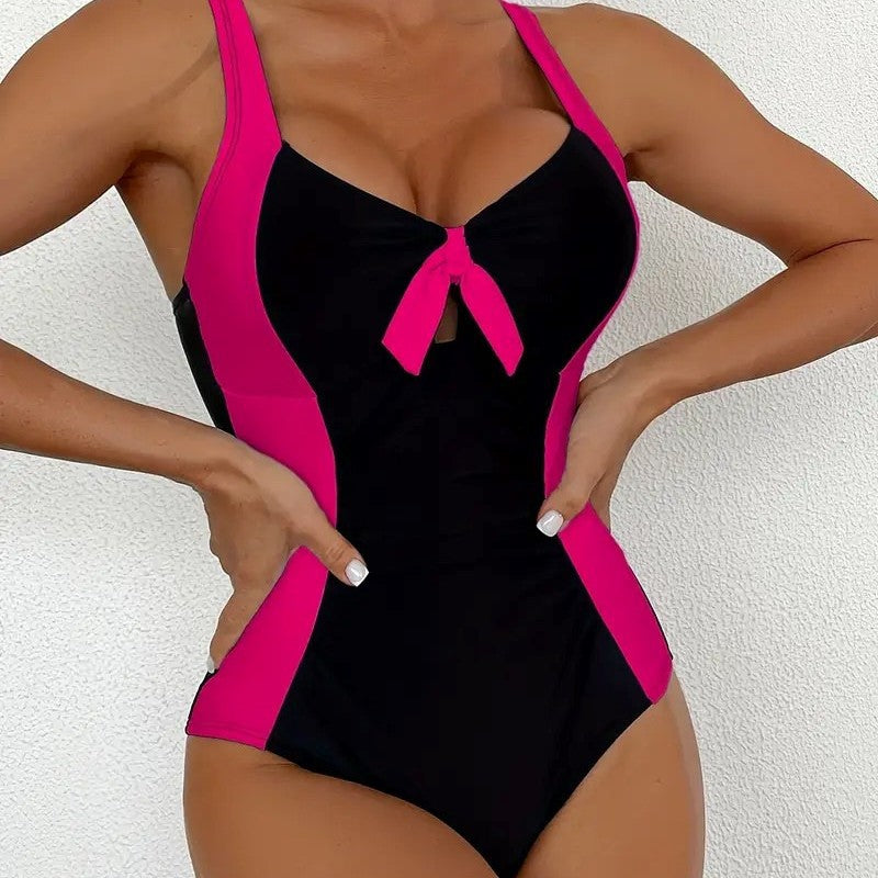 Fitted one‑piece swimsuit with bold color block panels and scoop neckline.