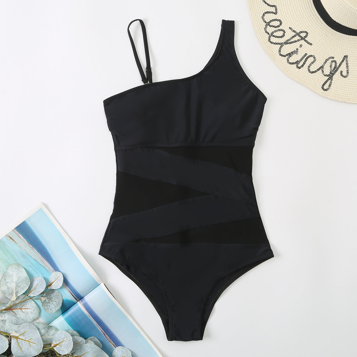 Black swimsuit with a tropical background sold at PeachyBeanz
