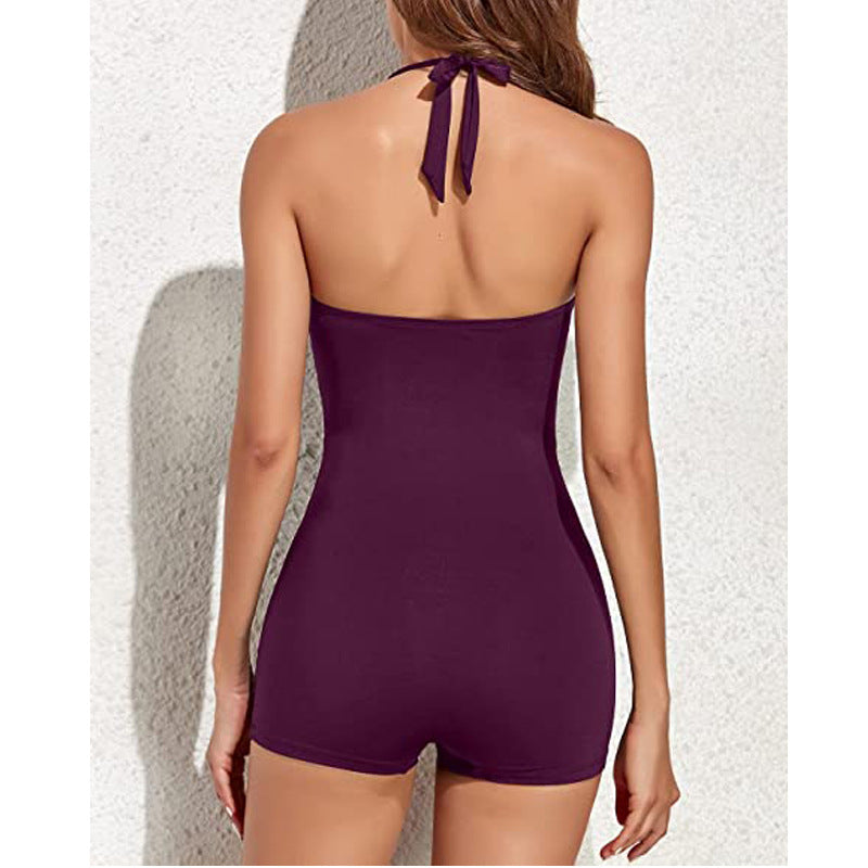 Purple halter neck swimsuit on a neutral background