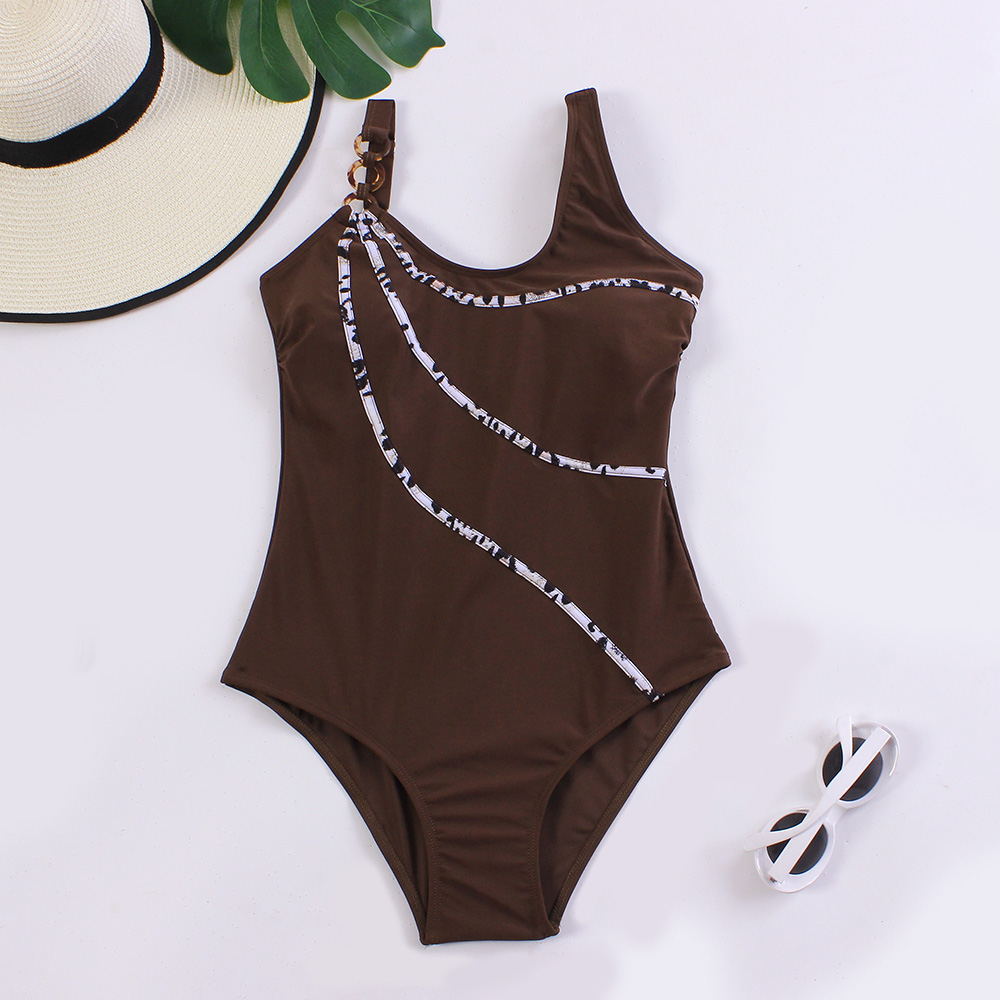Brown one-piece swimsuit with white pattern on a white background
