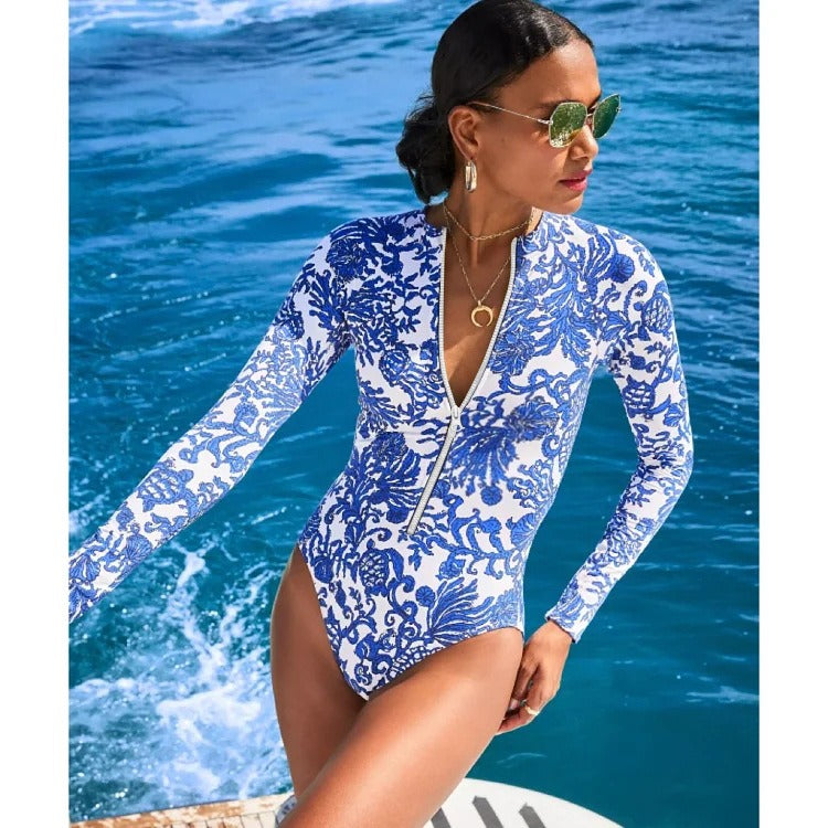 One‑piece swimsuit with blue cross‑border inspired print and scoop neckline.