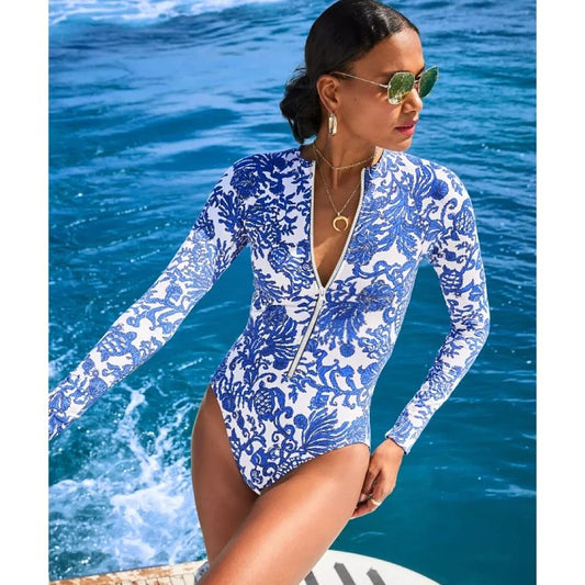 One‑piece swimsuit with blue cross‑border inspired print and scoop neckline.