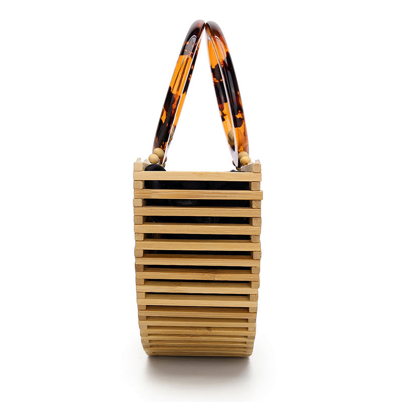 Close-up of a woven handbag with wooden beads and tortoiseshell accents sold at PeachyBeanz.