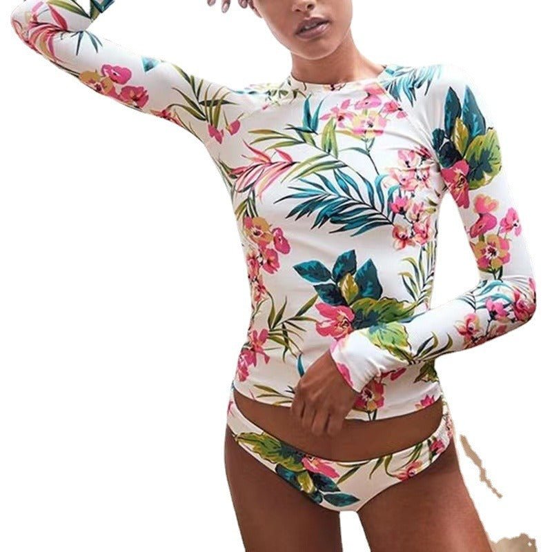 Person wearing a colorful floral long-sleeve top and shorts.