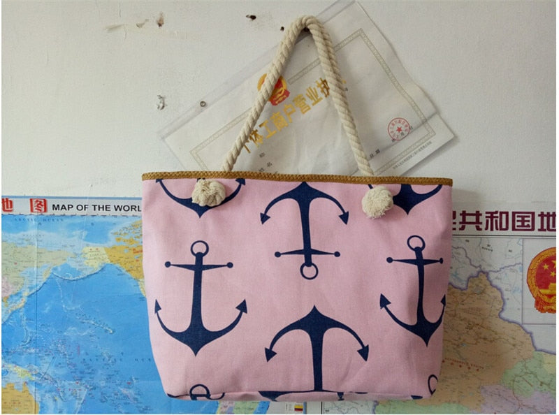 Pink tote bag with white anchor pattern on a white surface