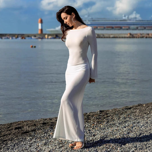 A lightweight, figure‑skimming cover up with a sleek backless silhouette that slips on over swimwear for effortless beach‑to‑boardwalk style.