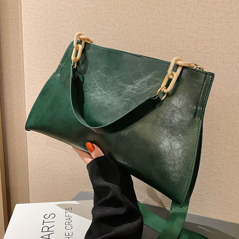 Large women's shoulder bag in soft faux leather, front view showing smooth finish and slim silhouette, black variant. Sold at PeachyBeanz.