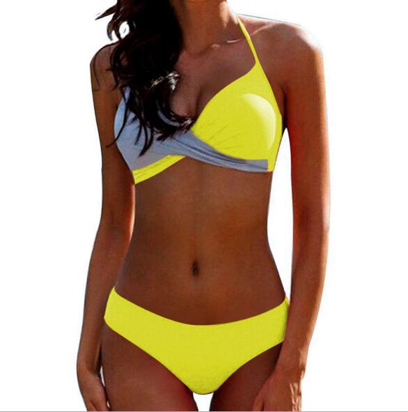 Two‑piece women’s bikini set featuring a padded push‑up top with spaghetti straps and a low‑waist patchwork bikini bottom, displayed in a flat lay on a neutral background.