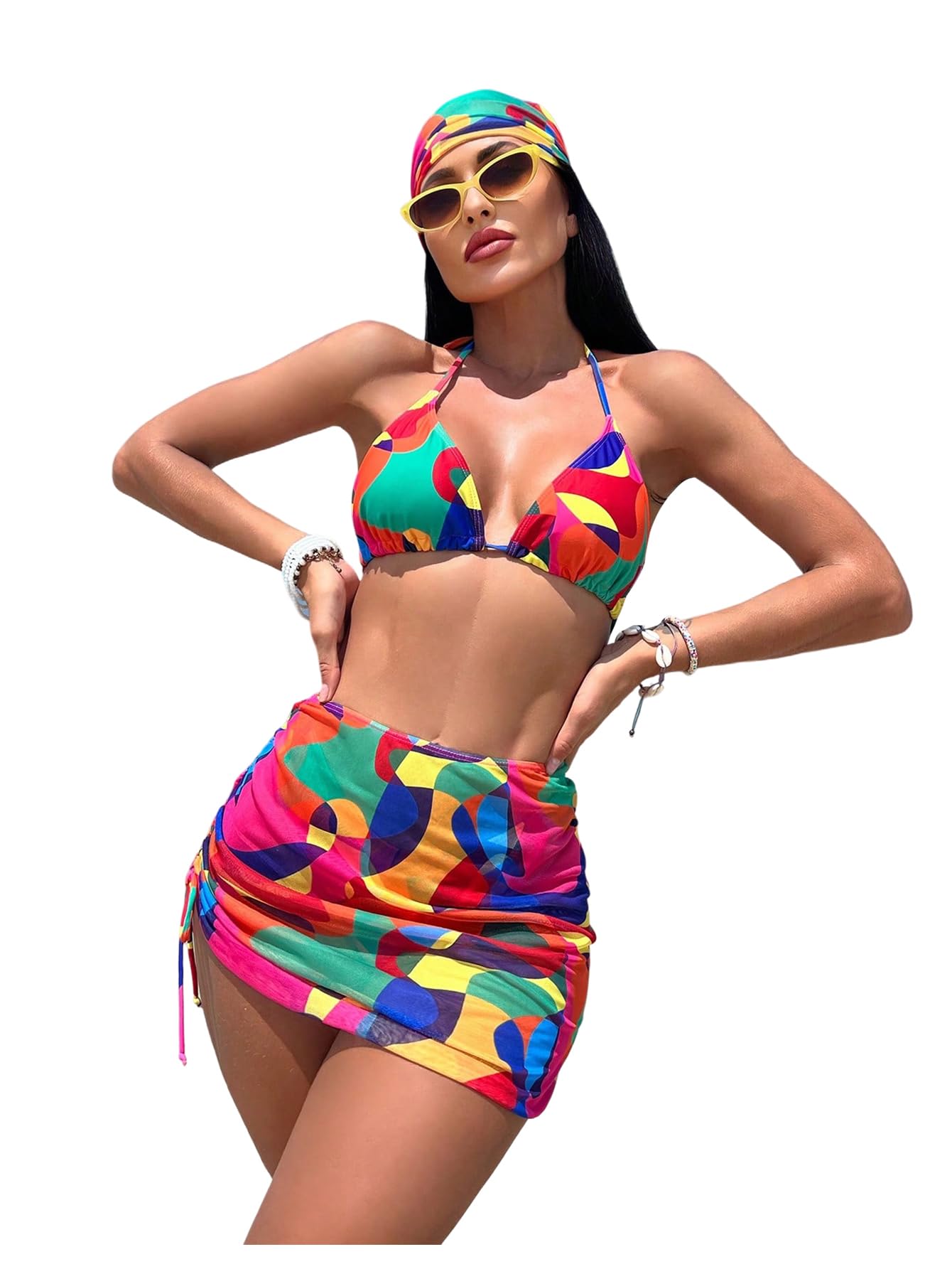 Woman wearing a colorful bikini and headscarf on a white background