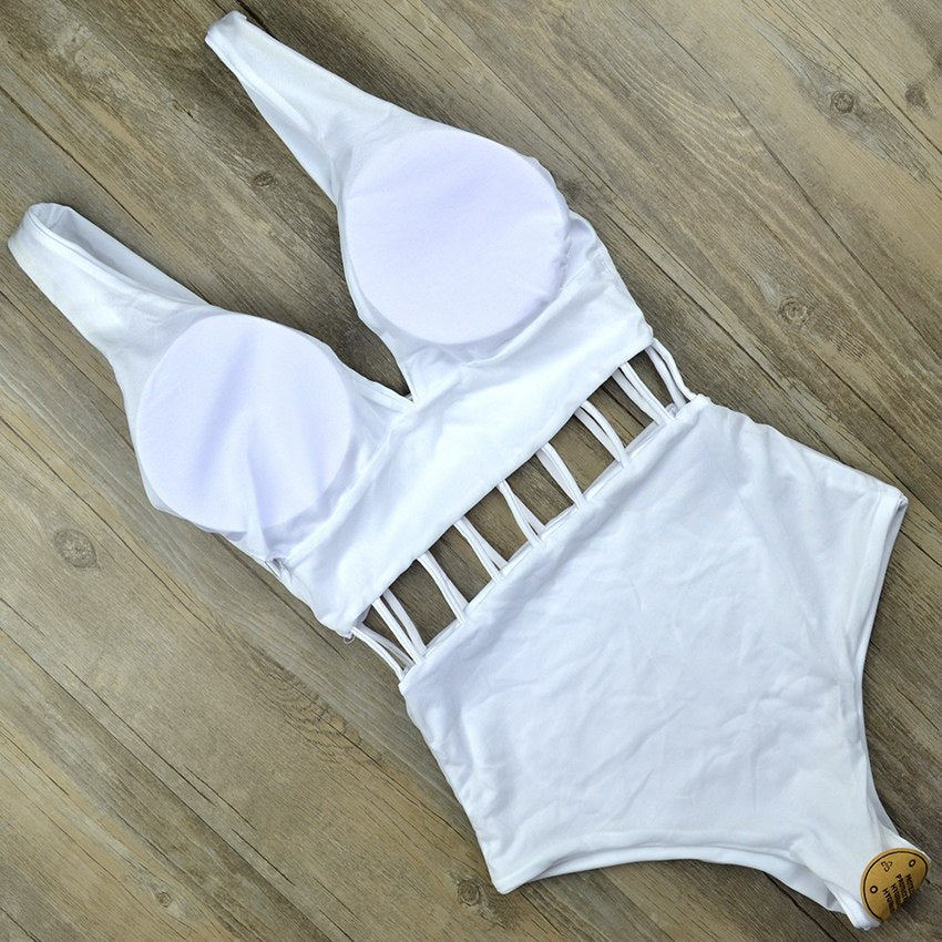 White V‑neck one‑piece monokini with hollow cut‑outs at the waist, sleeveless design, displayed on a plain background.