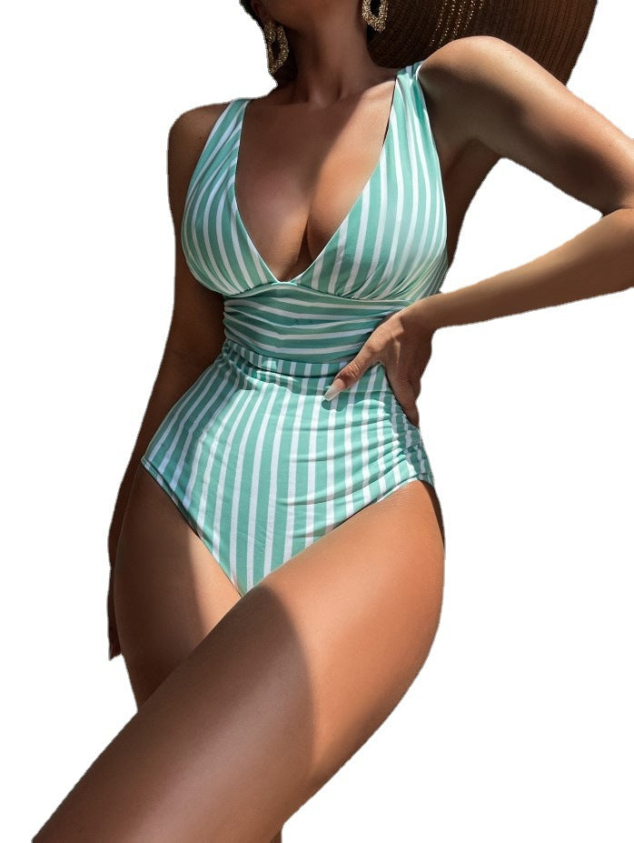 Striped one‑piece swimsuit with multicolor horizontal stripes, adjustable straps, and high‑cut leg.