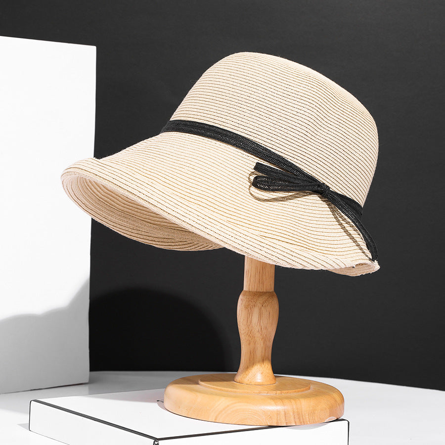 Close-up of a straw hat with a blue band on a white background