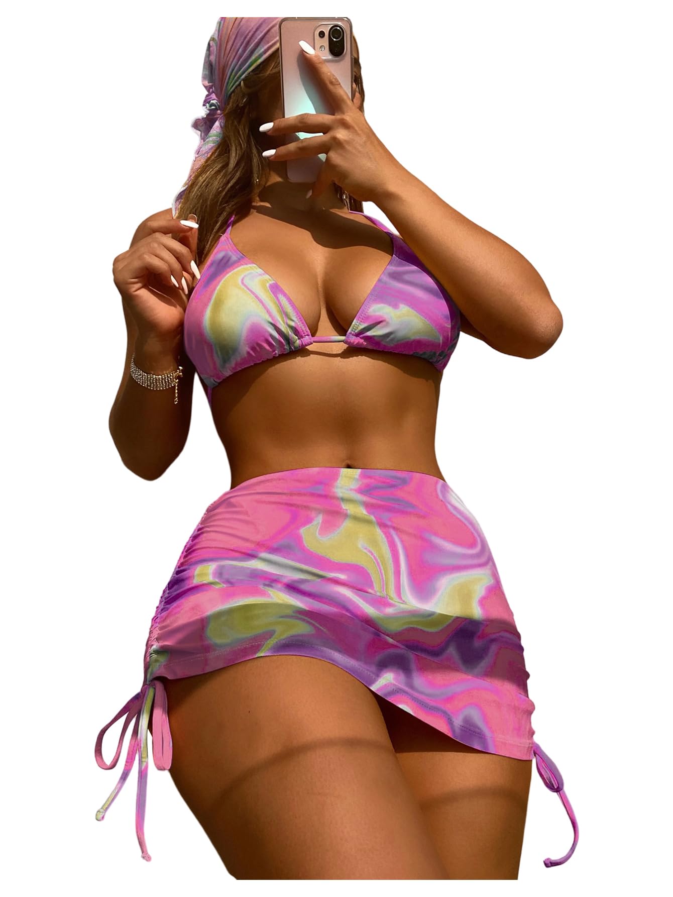 Woman taking a mirror selfie wearing a colorful bikini with a white background