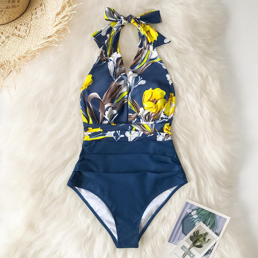 Blue mist floral one‑piece swimsuit with a backless design, sleeveless cut, and lightweight quick‑dry fabric.