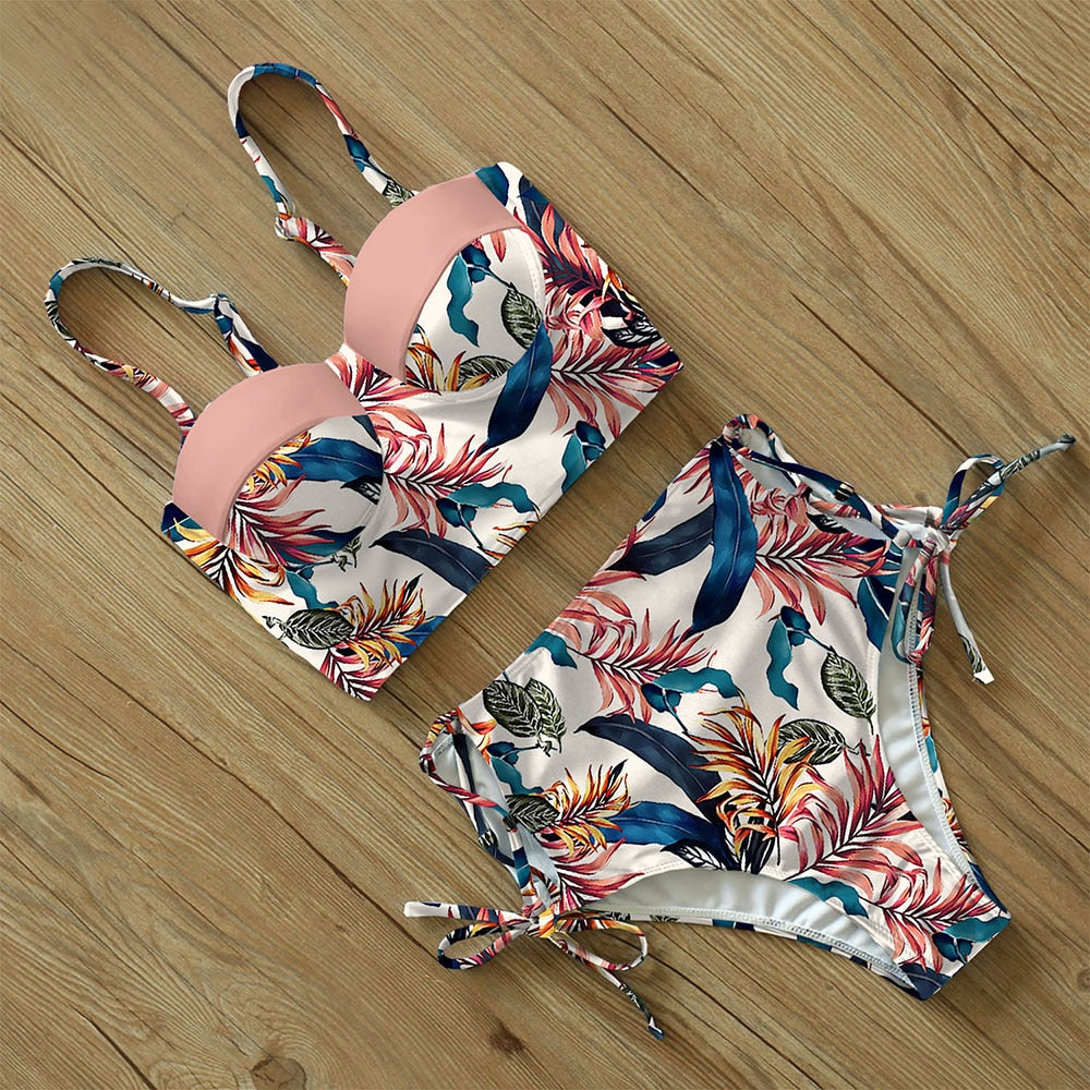 Woman in a pink floral swimsuit.