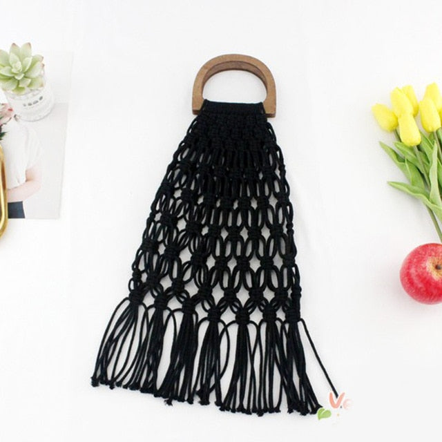 Black woven handbag with wooden handles.