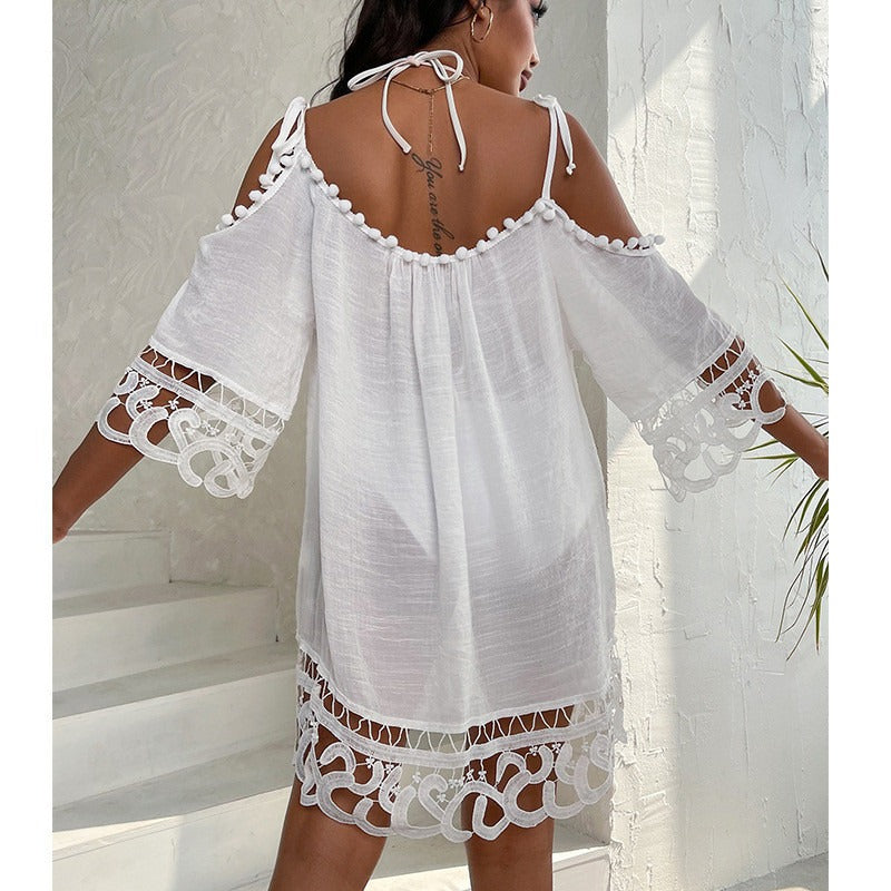 White lace dress swimsuit cover-up with cut-out sleeves and hem on a neutral background 