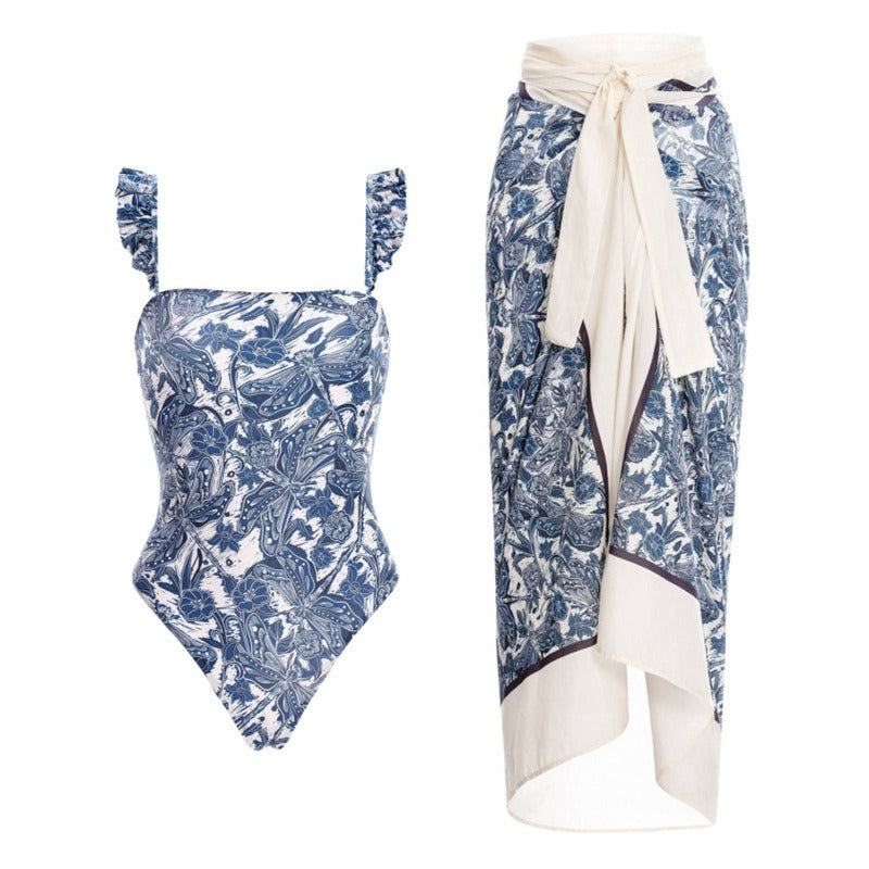 Blue floral swimsuit with a skirt coverup on a white background