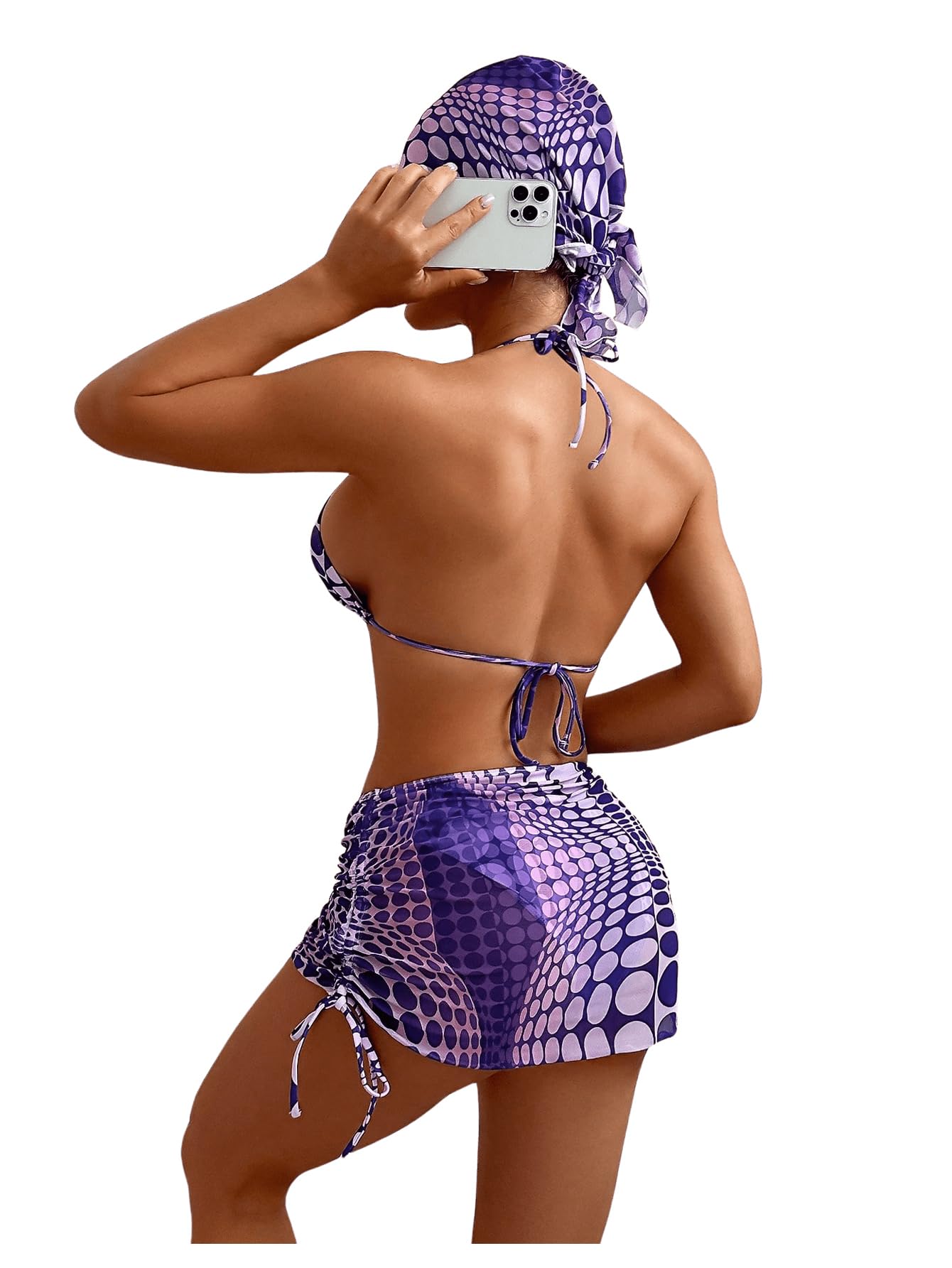 Person wearing a purple patterned swimsuit with a matching headscarf on a white background