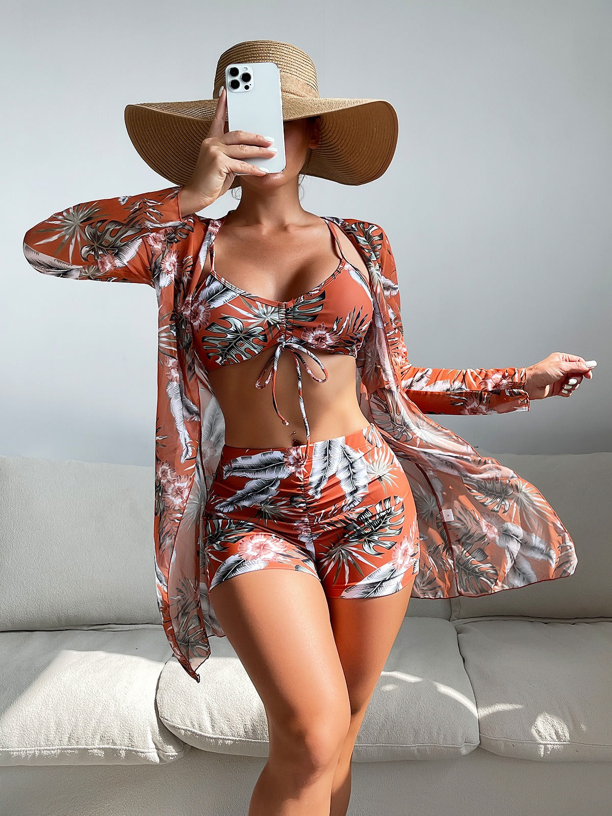 Three‑piece pattern print swimwear set featuring a supportive top, high‑waist bottoms, and coordinating cover or accessory piece; bold tropical foliage pattern and streamlined fit.