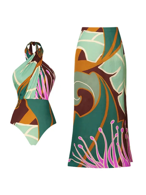 Halter printed one‑piece swimsuit with matching wrap skirt; plaid floral print in soft blue and brown, shown on neutral background. 