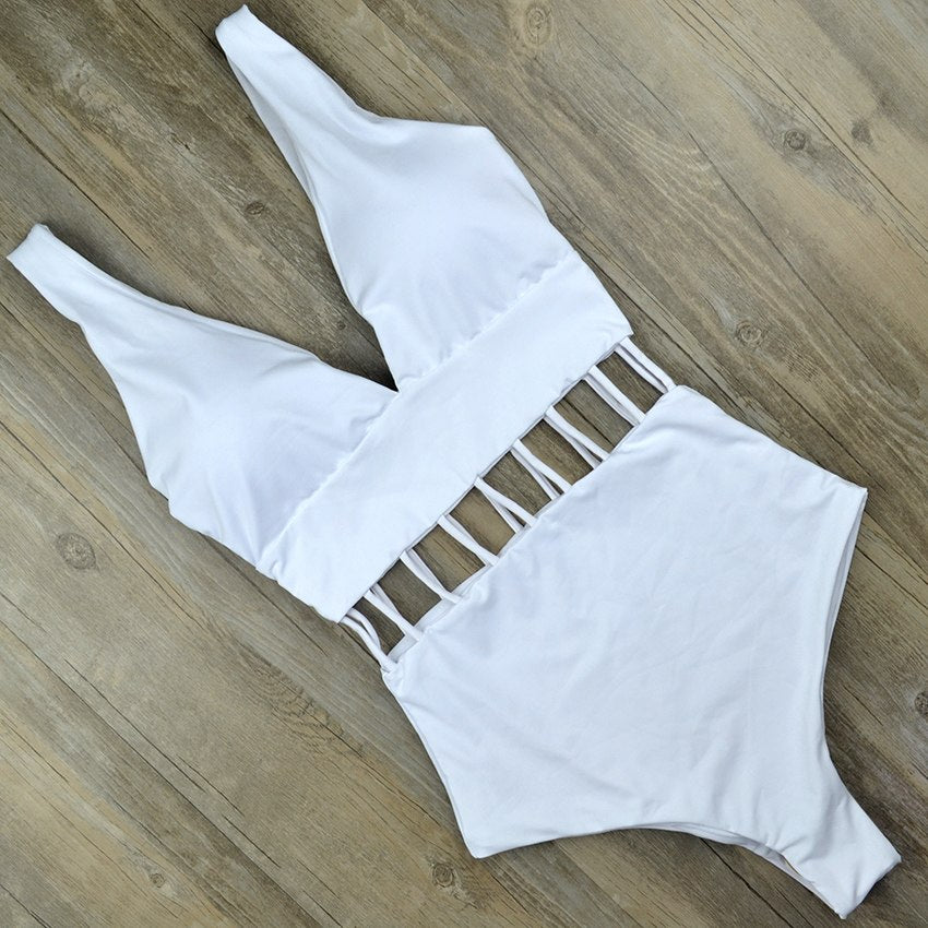 White V‑neck one‑piece monokini with hollow cut‑outs at the waist, sleeveless design, displayed on a plain background.