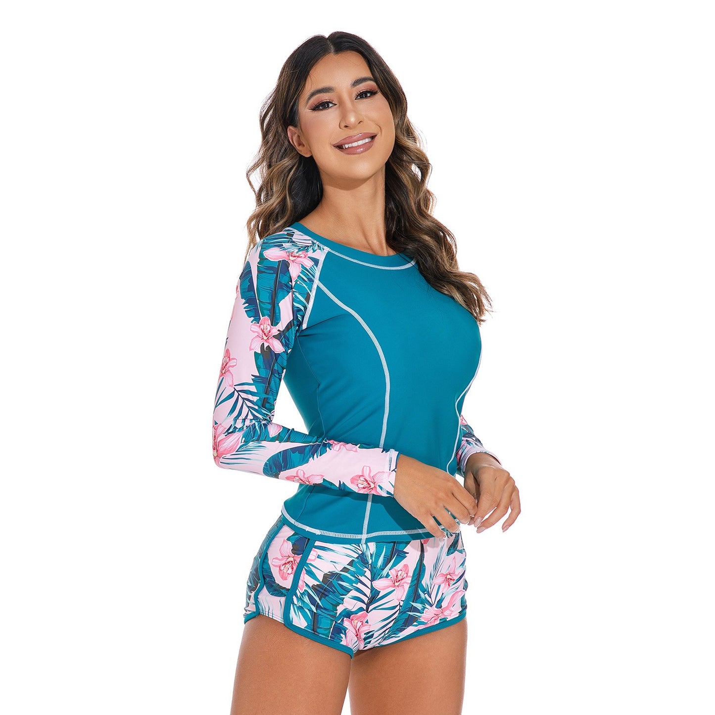 Long‑sleeved peacock‑blue pullover swimsuit top paired with matching bottoms, displayed in a studio product photo against a plain background.