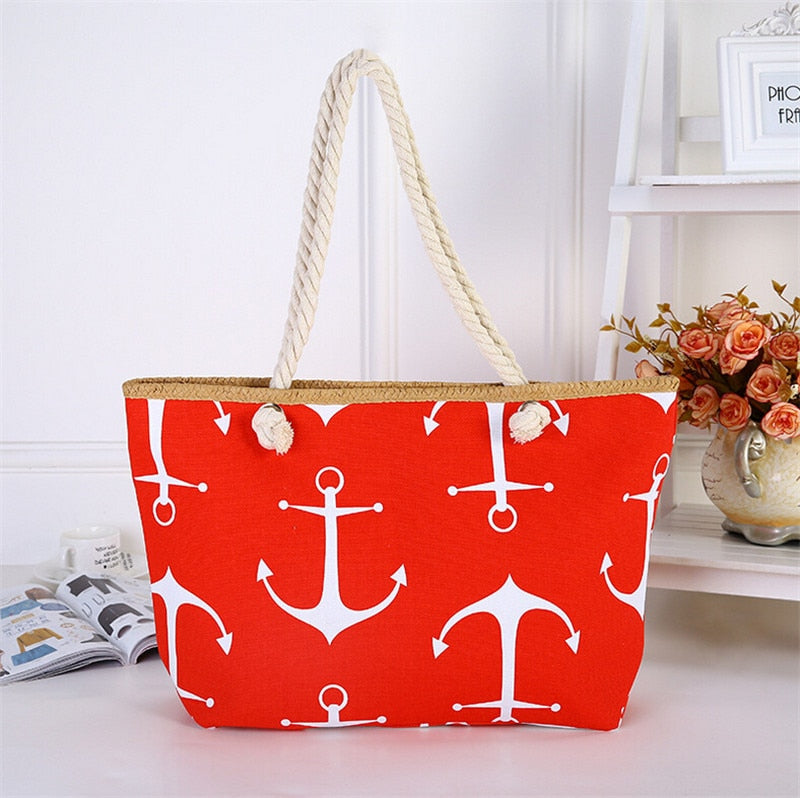 Red tote bag with white anchor pattern on a white surface