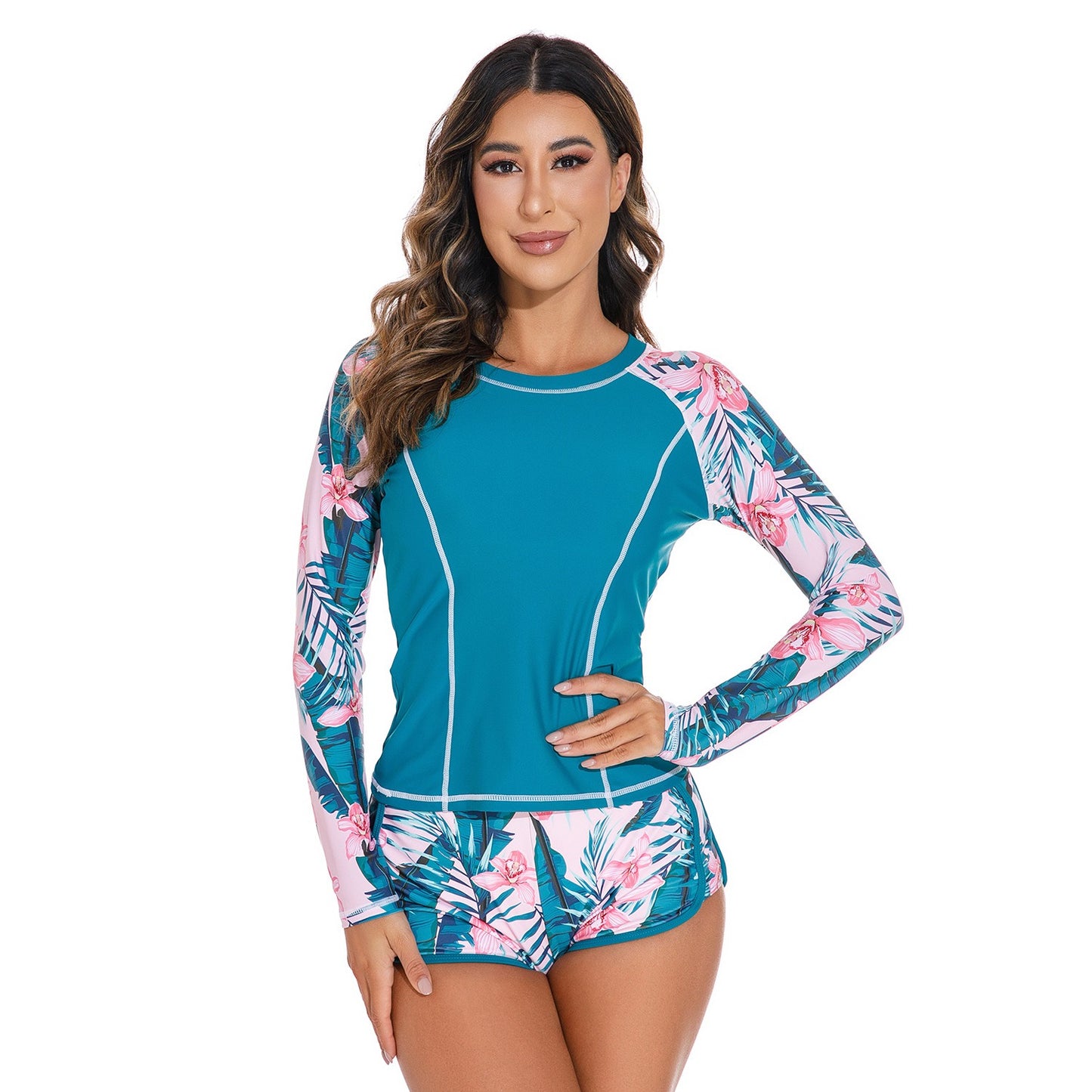 Long‑sleeved peacock‑blue pullover swimsuit top paired with matching bottoms, displayed in a studio product photo against a plain background.