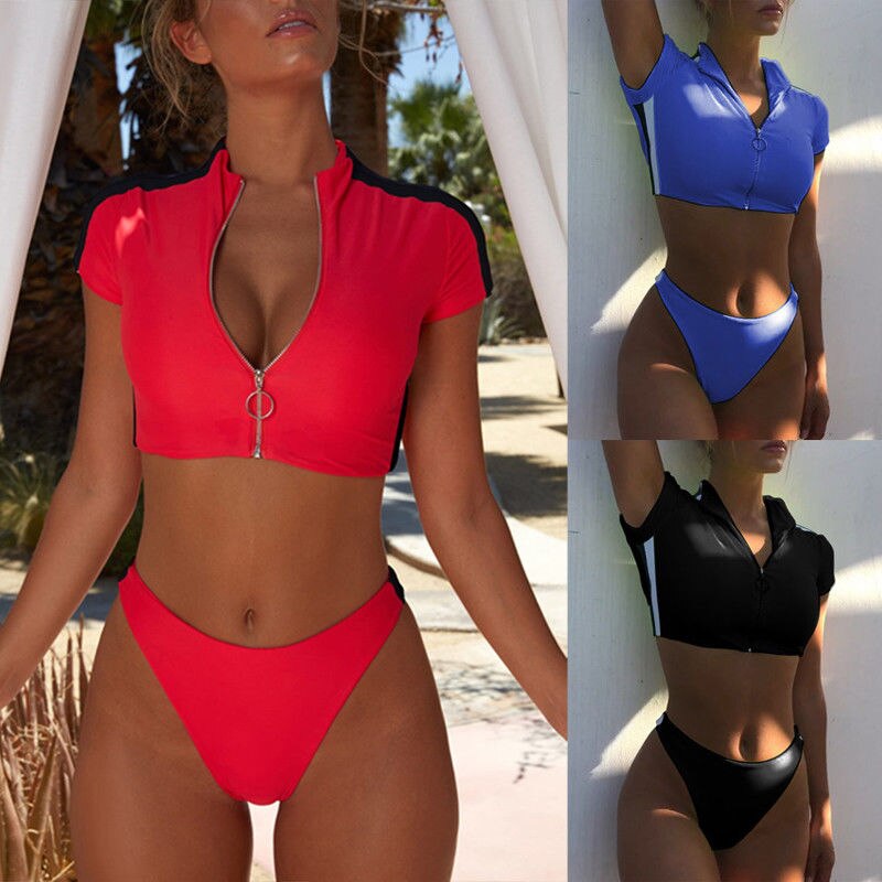 Women’s short‑sleeve two‑piece swimsuit with a front zip‑up top and matching bikini bottoms, shown in a solid color on a plain background.