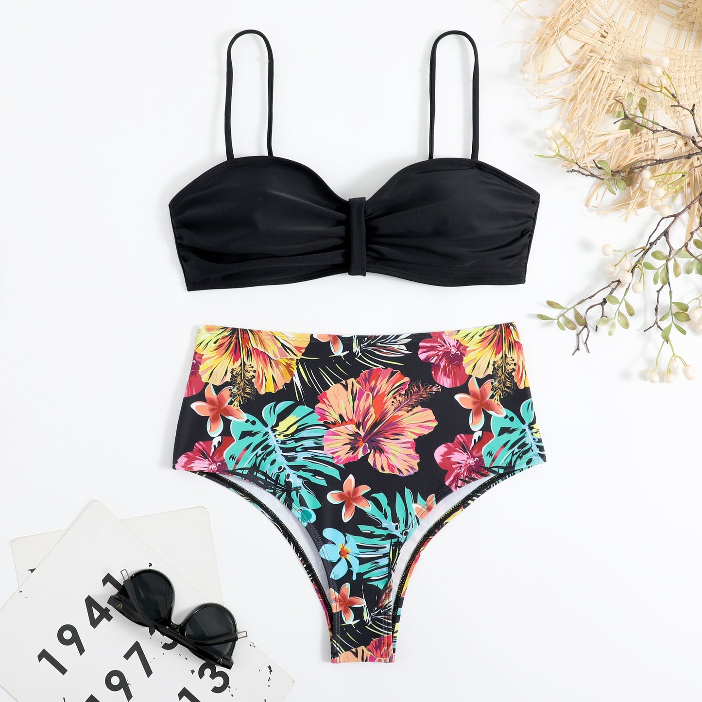 This two‑piece high‑waist bikini features a fragmented floral pattern blending bright color with a flattering, modern silhouette. 