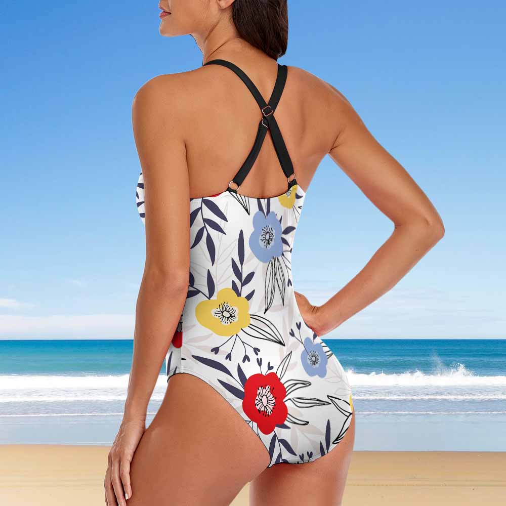 Woman wearing a floral swimsuit against a beachy background sold at PeachyBeanz.