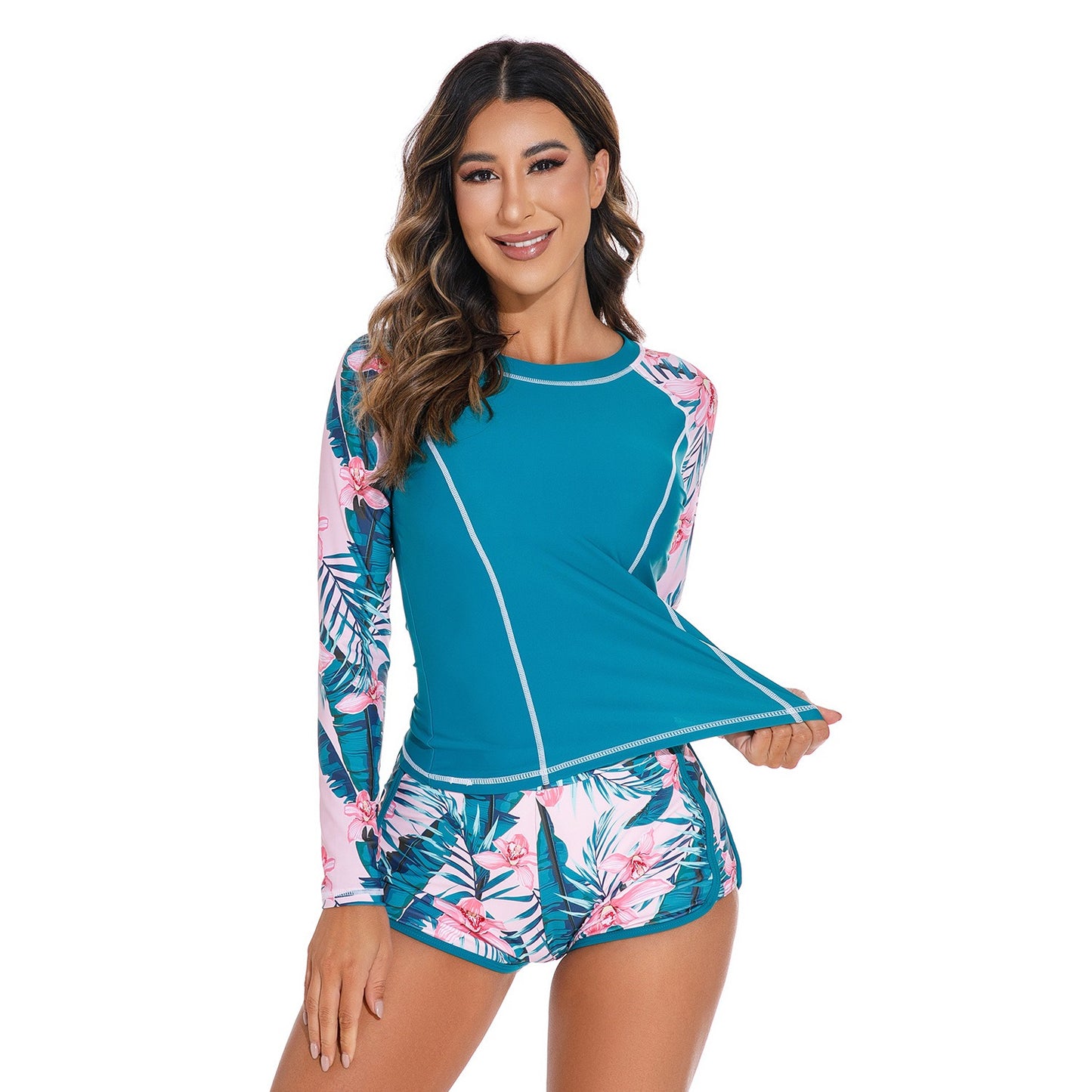 Long‑sleeved peacock‑blue pullover swimsuit top paired with matching bottoms, displayed in a studio product photo against a plain background.