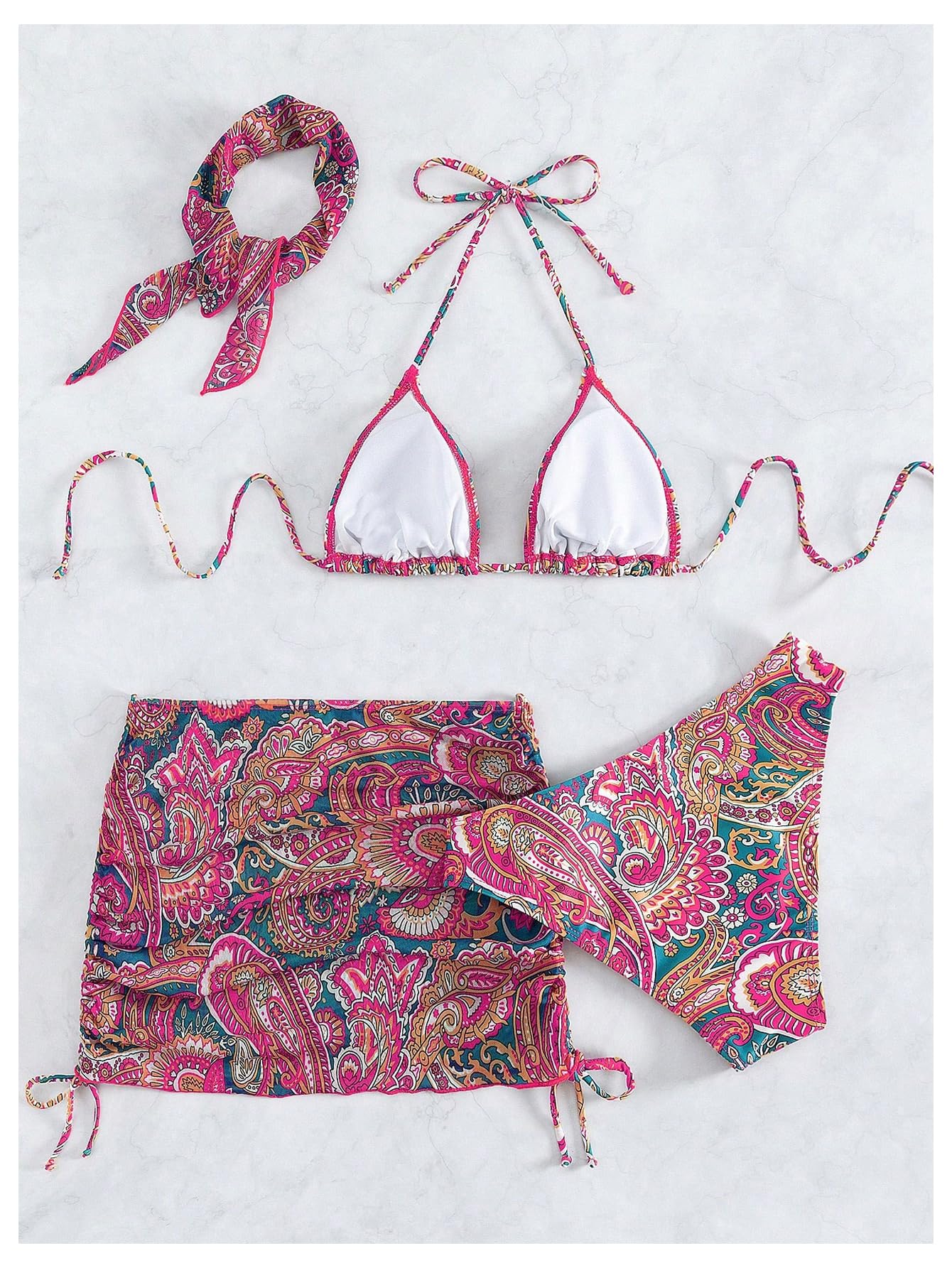 Paisley-patterned bikini set with matching accessories on a white background
