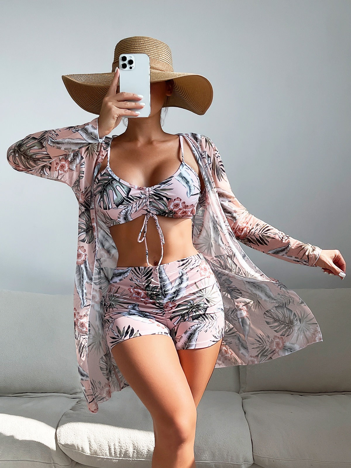 Three‑piece pattern print swimwear set featuring a supportive top, high‑waist bottoms, and coordinating cover or accessory piece; bold tropical foliage pattern and streamlined fit.