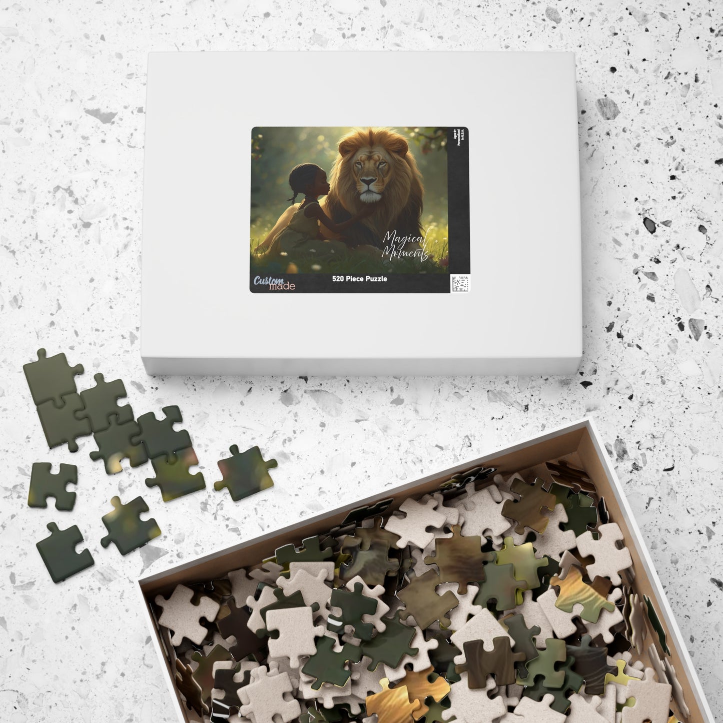 Jigsaw puzzle set with a box featuring an image of a lion and child on a speckled surface.