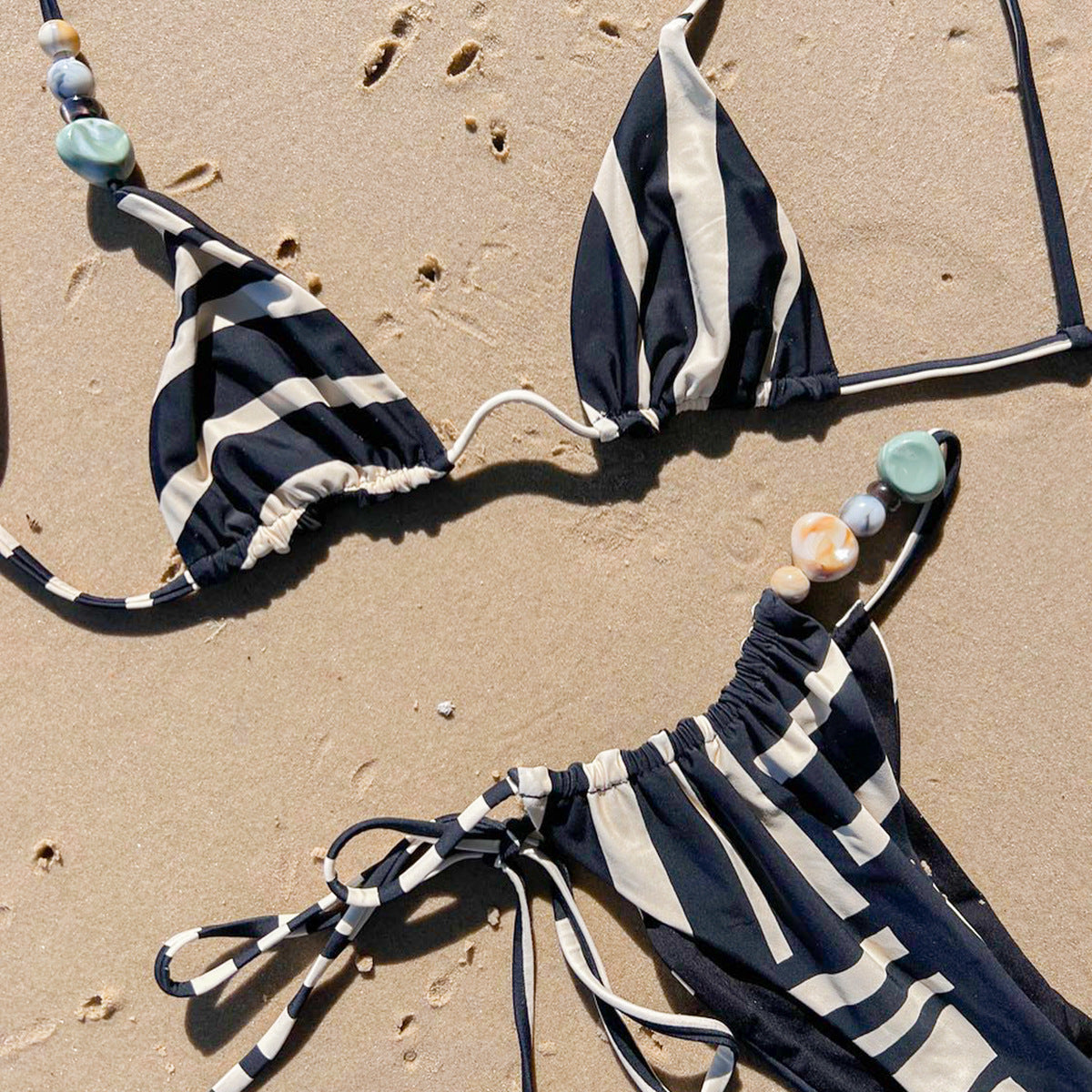 Two‑piece women’s bikini set in black or red spliced solid‑color design, featuring a sleeveless triangle top and high‑elasticity fitted bottoms.