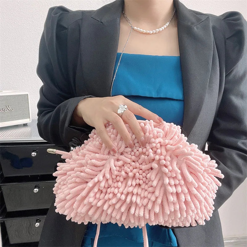Person holding a pink textured handbag against a white wall sold at PeachyBeanz.