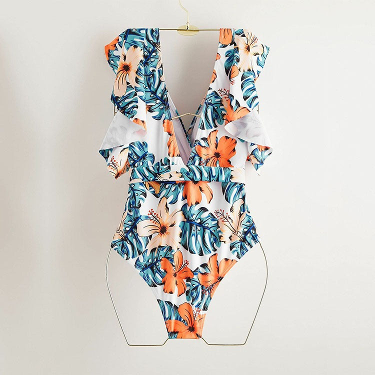 Backless short‑sleeve one‑piece swimsuit with fragmented flowers print; polyester shell 82% polyester fiber, 100% polyester lining, chest pad without steel support, quick‑drying, highly elastic, widened and thickened panels, ideal for fitness, cycling, and water sports.