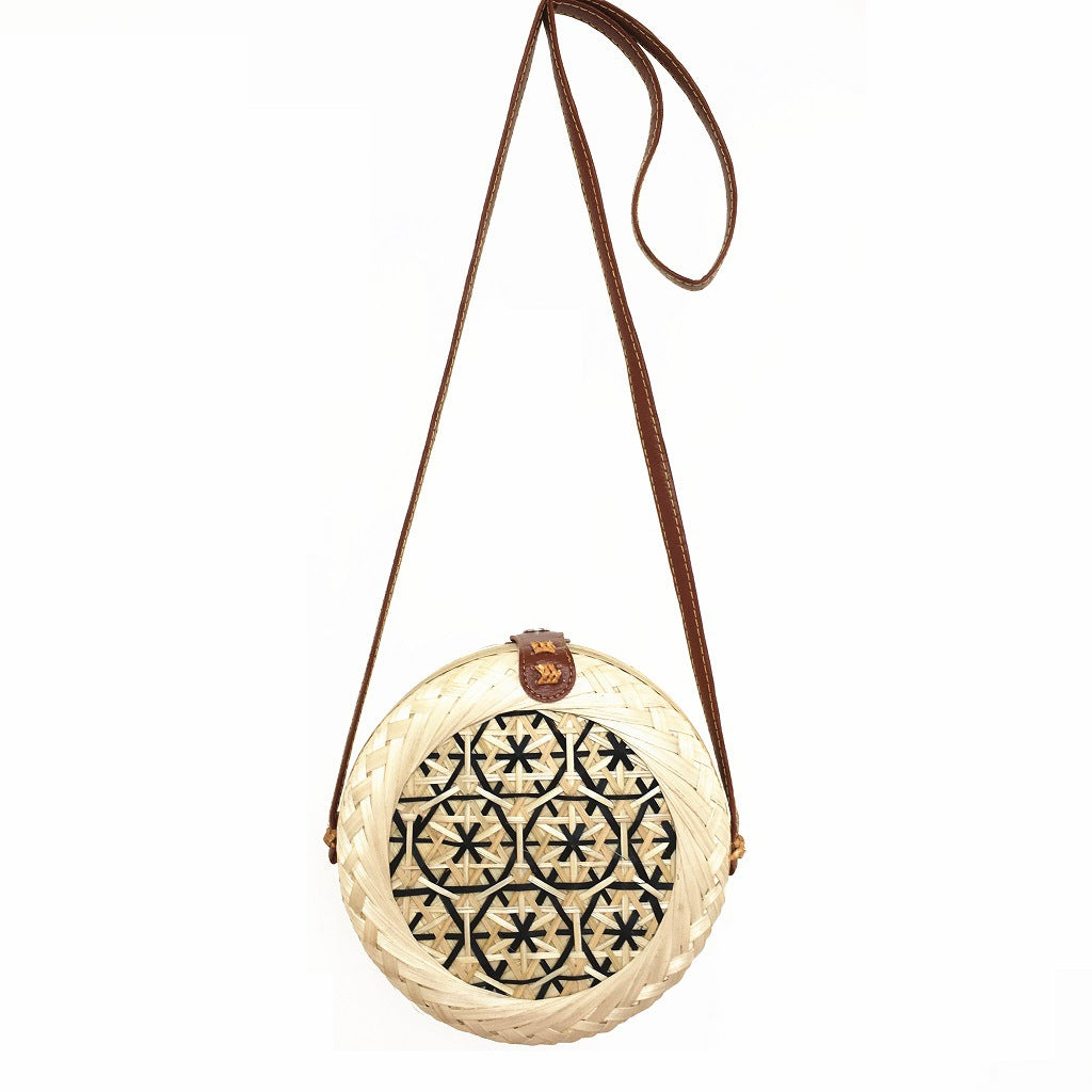 Woven basket with decorative lid on a white background