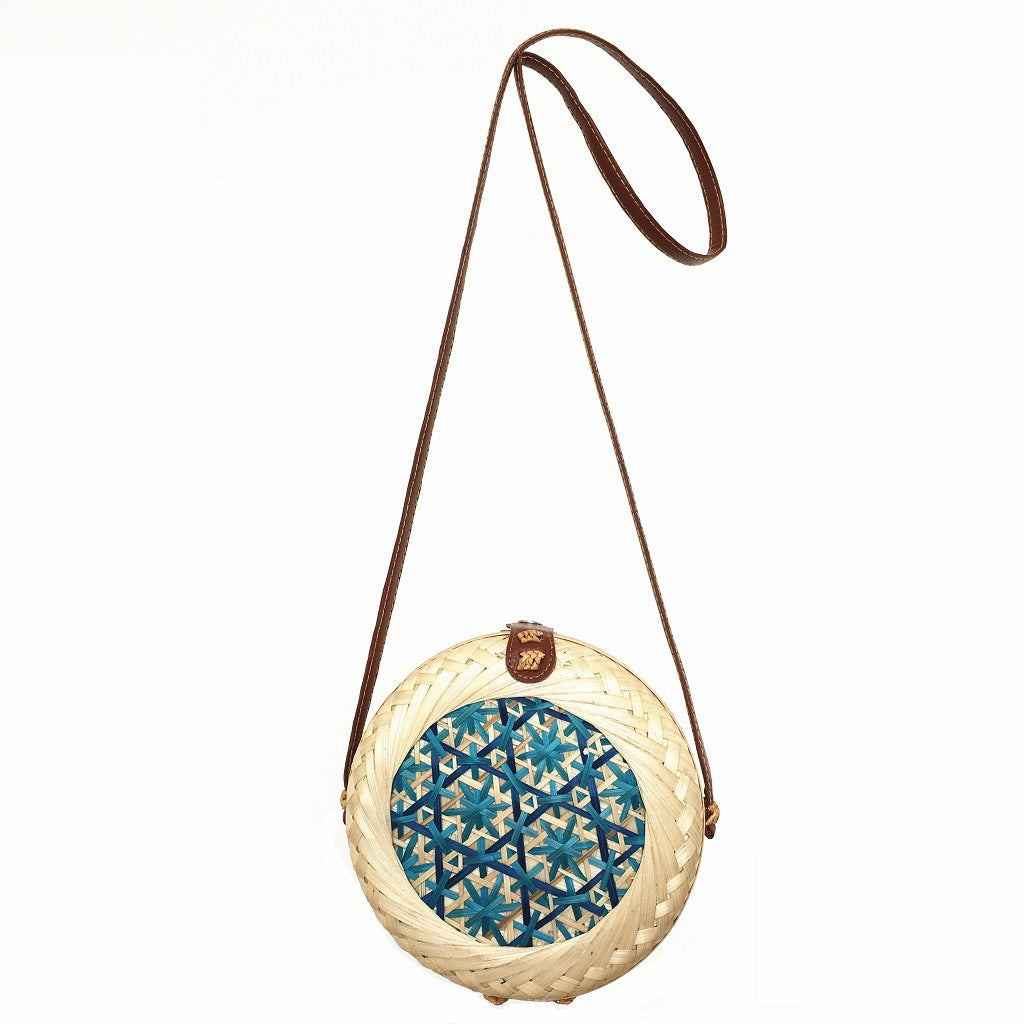 Woven basket with decorative lid on a white background