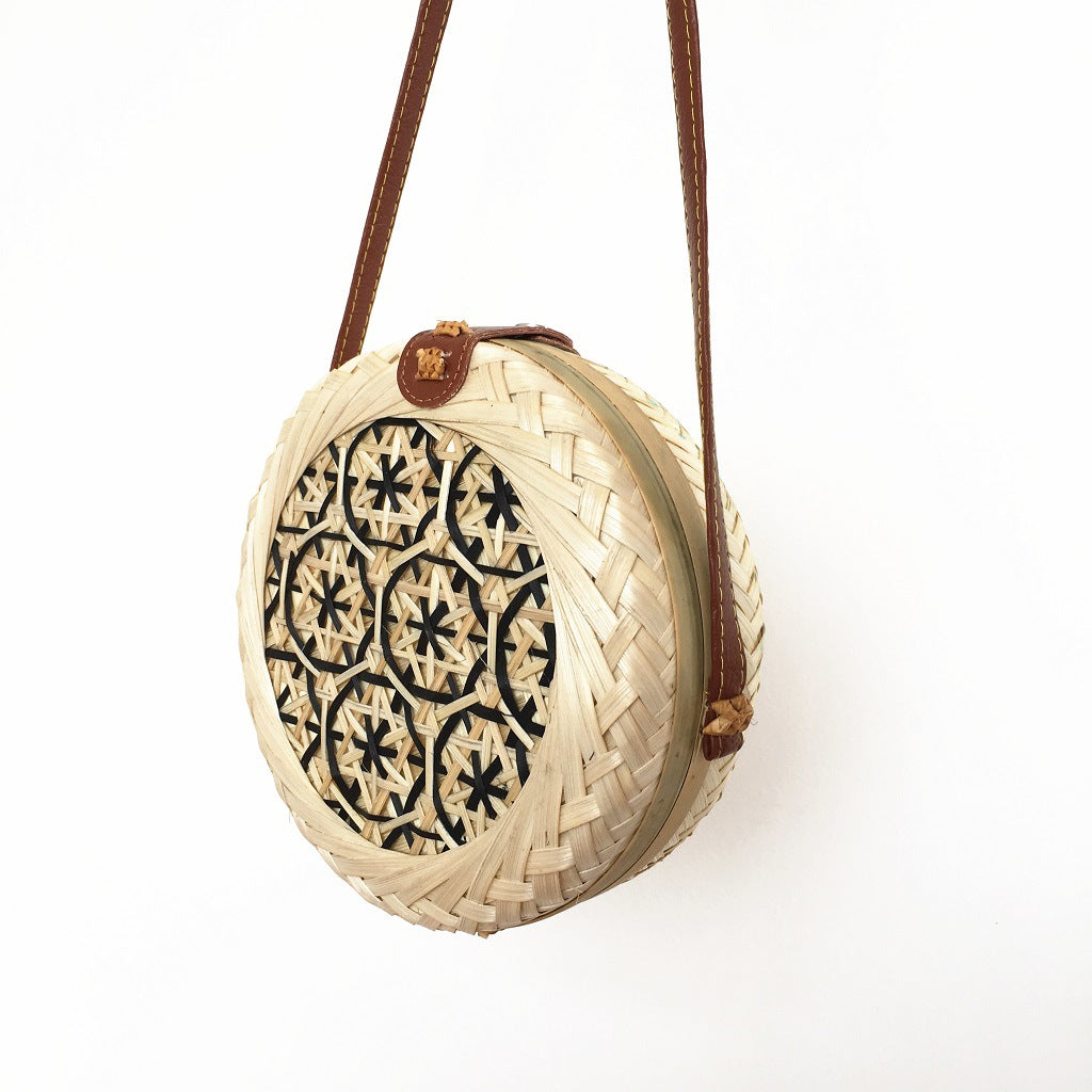 Woven basket with decorative lid on a white background