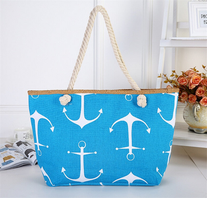 Light blue tote bag with white anchor pattern on a white surface